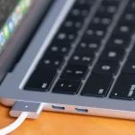 MacBook Air M4 (2025) on a desk next to a coffee mug, showing its thin design and sleek form factor