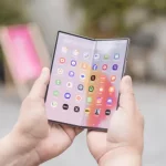 Samsung Galaxy Z Fold6 unfolded on a wooden desk with stylus
