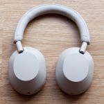 Sony WH-1000XM5 wireless noise-canceling headphones in black, on a work desk setup