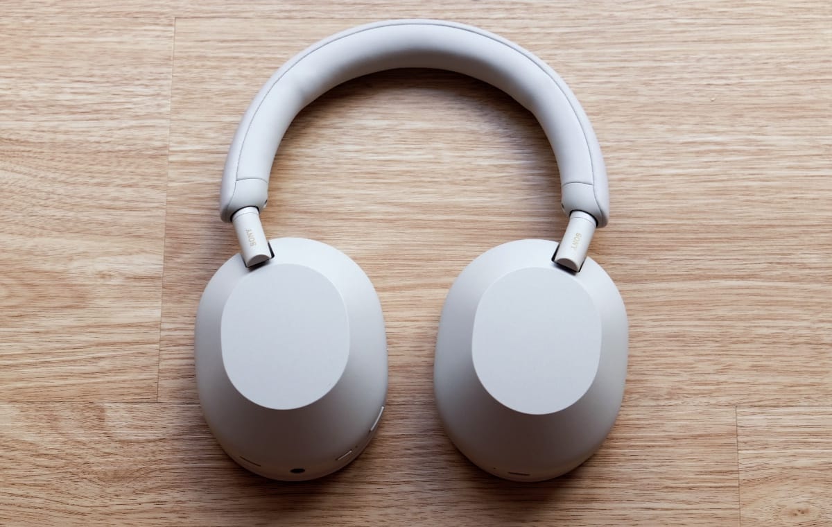 Sony WH-1000XM5 wireless noise-canceling headphones in black, on a work desk setup