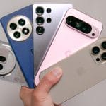 Person comparing different smartphones on display table with buying guide checklist - Complete smartphone buying guide 2025 for choosing the best phone