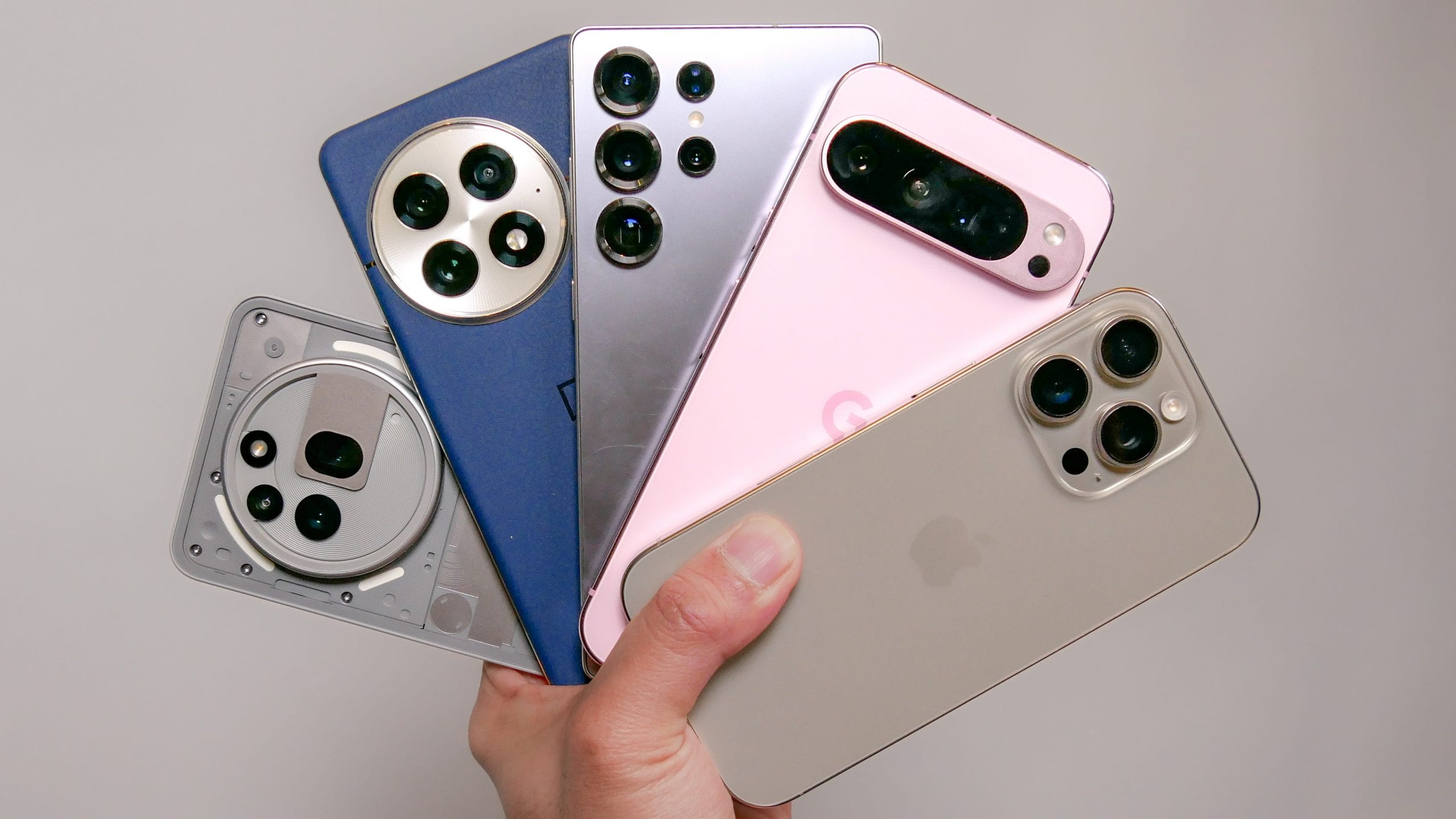 Person comparing different smartphones on display table with buying guide checklist - Complete smartphone buying guide 2025 for choosing the best phone