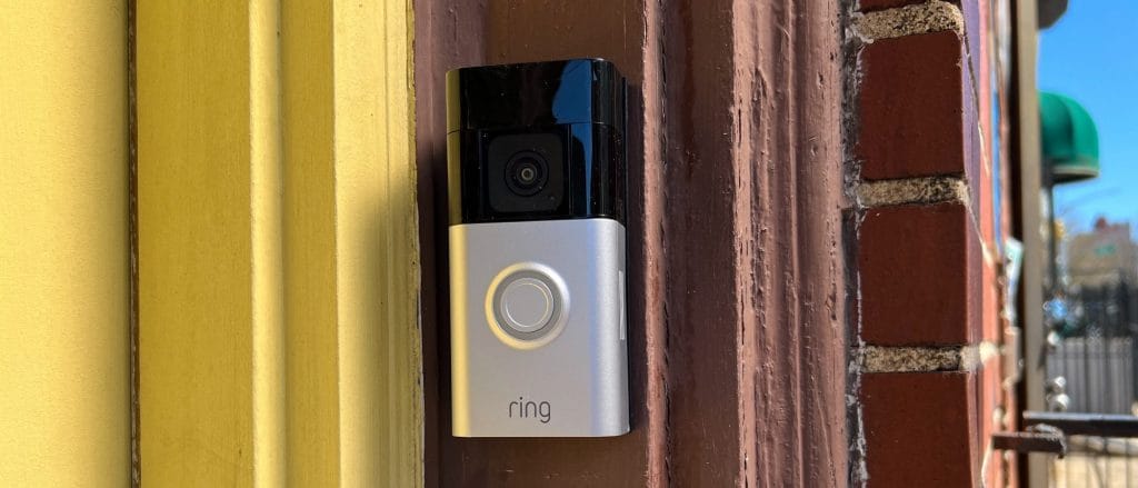 Ring Battery Doorbell Plus installed on front door showing sleek black design and LED indicator