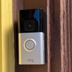 Ring Battery Doorbell Plus installed on front door showing sleek black design and LED indicator