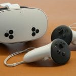 Meta Quest 3S VR headset front view showing controllers and passthrough cameras