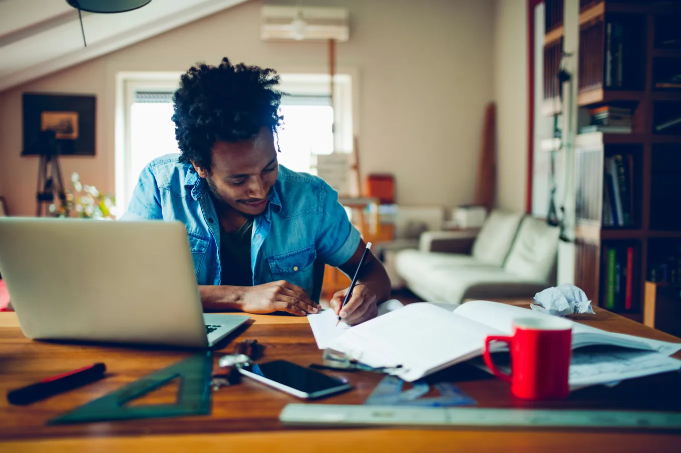 A person working efficiently in a bright, organized home office, demonstrating productivity hacks for working from home.